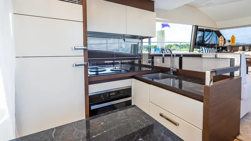 Slide: The Image of Luxurious kitchen interior of 2019 Prestige 520 Flybridge yacht with modern appliances and sleek design. - 8