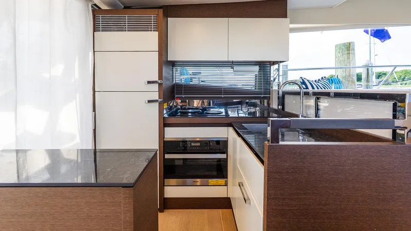 Slide: The Image of Modern kitchen interior on 2019 Prestige 520 Flybridge yacht, featuring sleek cabinetry and appliances. - 9
