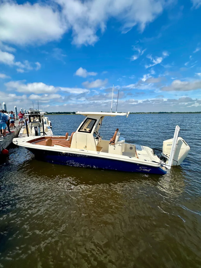 Slide: The Image of 2026 Scout 261 XSS boat docked on a sunny day with blue skies. - 10