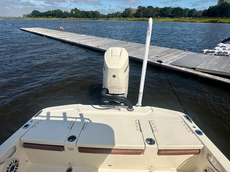 Slide: The Image of 2026 Scout 261 XSS boat docked on calm water with scenic background. - 7