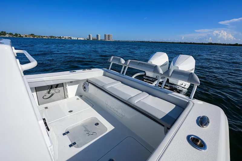 Slide: The Image of 2021 Yellowfin 26 Hybrid boat on water, featuring dual engines and spacious seating. - 10