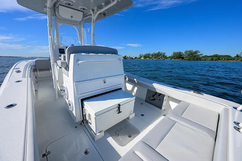 Slide: The Image of 2021 Yellowfin 26 Hybrid boat interior on calm blue water. - 12