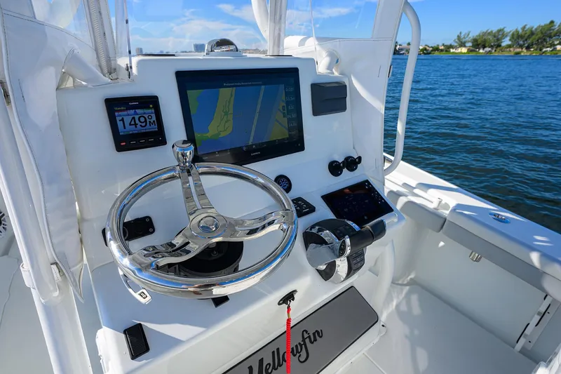 Slide: The Image of 2021 Yellowfin 26 Hybrid boat dashboard with navigation screens and steering wheel. - 14