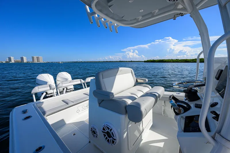 Slide: The Image of 2021 Yellowfin 26 Hybrid boat interior with seating, ocean view, and clear blue sky. - 16