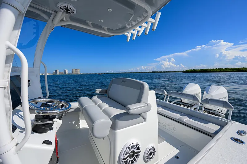 Slide: The Image of 2021 Yellowfin 26 Hybrid boat interior with ocean view, featuring modern seating and controls. - 17