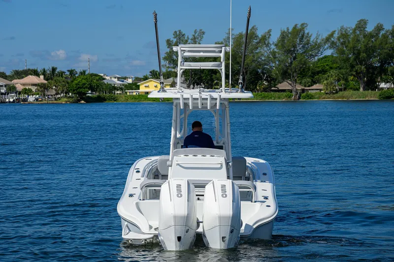 Slide: The Image of 2021 Yellowfin 26 Hybrid boat on water, rear view with dual engines. - 3