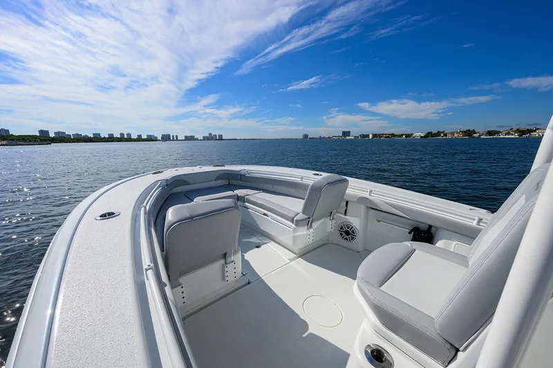 Slide: The Image of 2021 Yellowfin 26 Hybrid boat on calm water under a clear blue sky. - 6