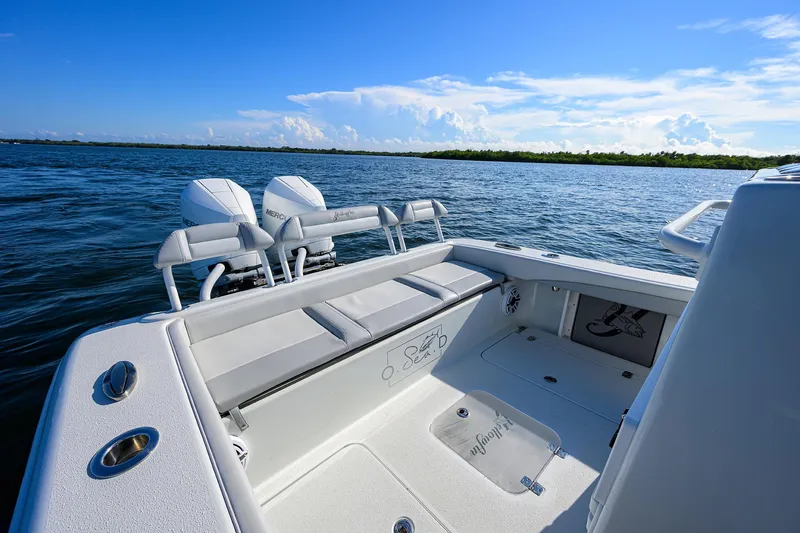 Slide: The Image of 2021 Yellowfin 26 Hybrid boat on open water, featuring dual engines and spacious deck. - 8