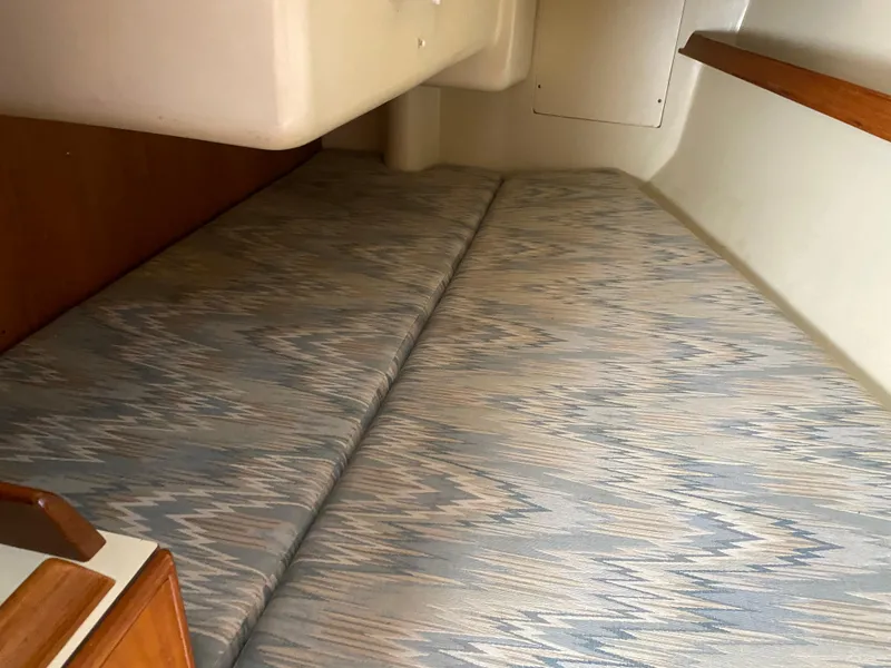 Slide: The Image of Interior cabin of 1988 Pearson 28 sailboat with patterned cushions. - 16