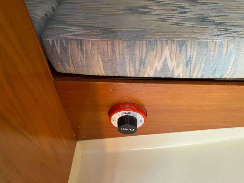 Slide: The Image of Boat interior with a blue cushion and a red battery switch, Pearson 28, 1988 model. - 17