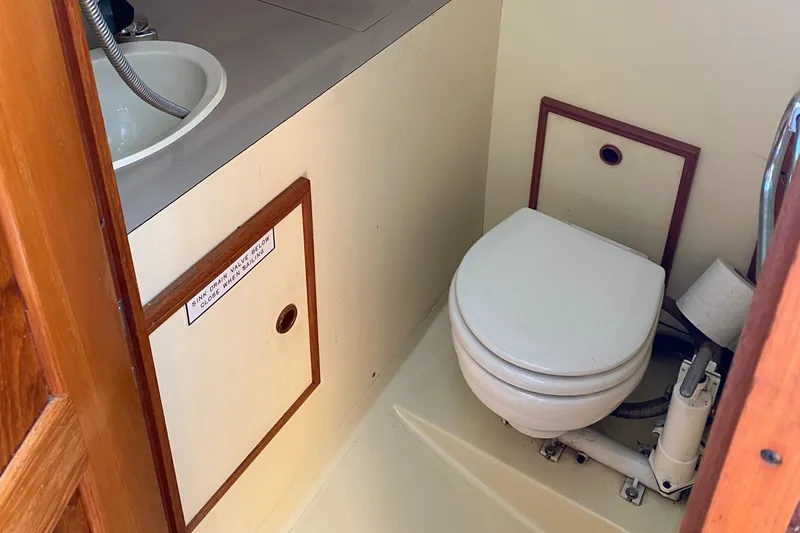 Slide: The Image of Compact bathroom in 1988 Pearson 28 sailboat with toilet and sink. - 19