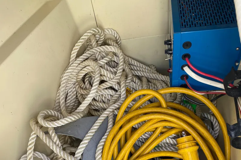 Slide: The Image of Coiled ropes and cables in a 1988 Pearson 28 boat compartment. - 20