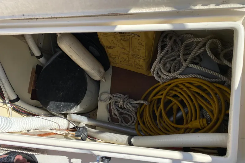 Slide: The Image of Storage compartment on a 1988 Pearson 28 sailboat with ropes and equipment. - 21