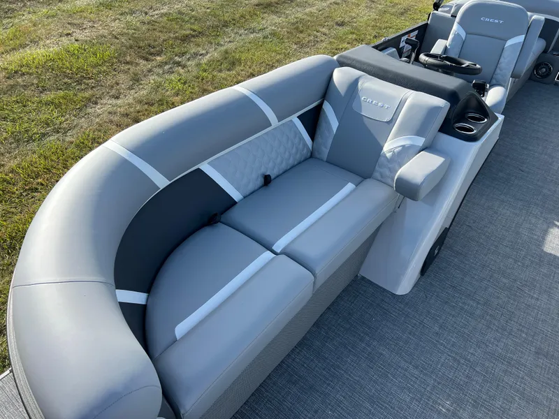Slide: The Image of 2025 Crest CLASSIC 220 SLC boat interior with gray seating and modern design. - 14