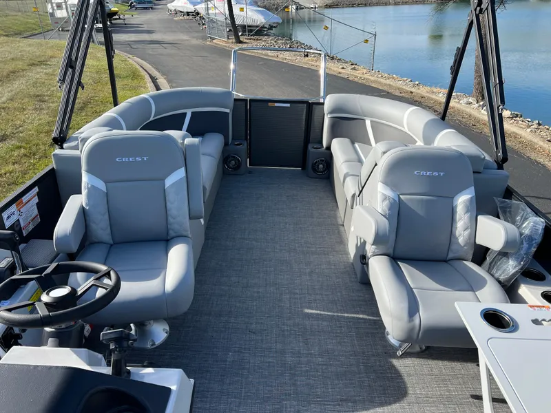 Slide: The Image of 2025 Crest CLASSIC 220 SLC pontoon boat with spacious seating and modern design. - 16