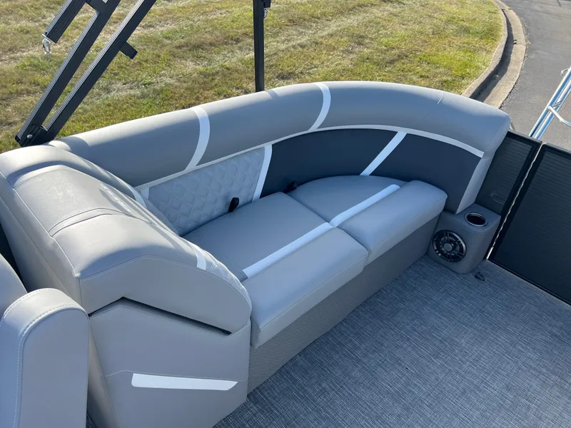 Slide: The Image of 2025 Crest CLASSIC 220 SLC boat interior with gray seating and cup holder. - 18