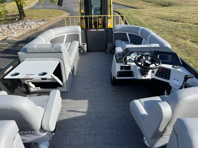 Slide: The Image of 2025 Crest CLASSIC 220 SLC pontoon boat interior with gray seating and modern helm. - 22