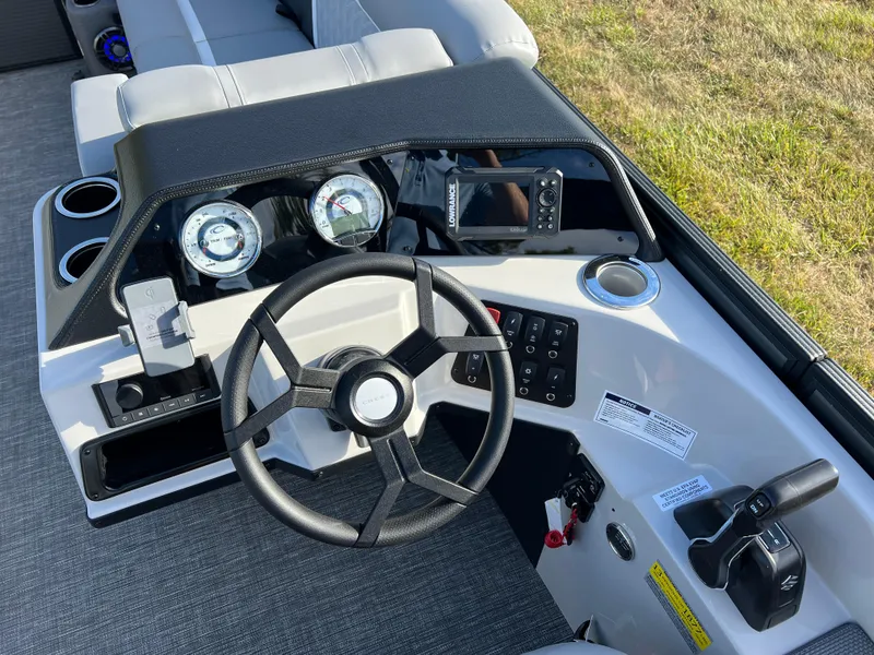 Slide: The Image of Steering console of 2025 Crest CLASSIC 220 SLC boat with gauges and controls. - 24