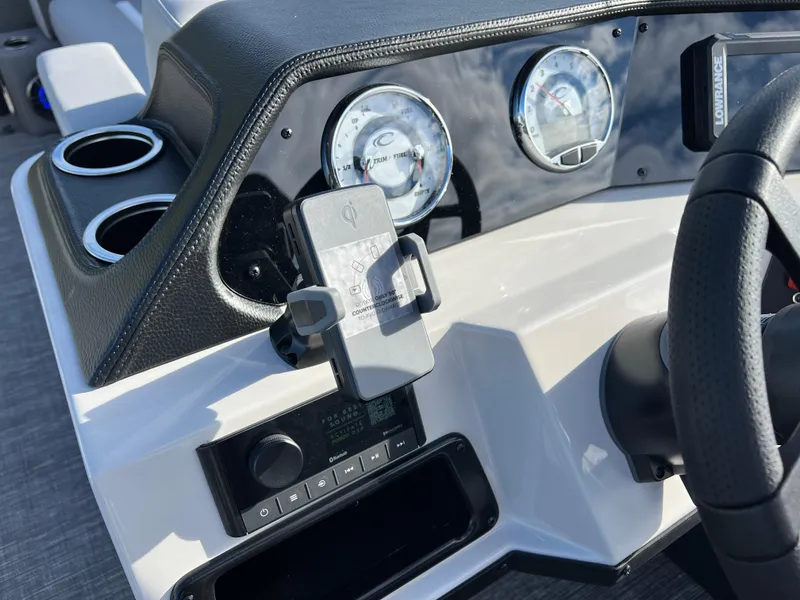 Slide: The Image of Dashboard of 2025 Crest CLASSIC 220 SLC boat with gauges and phone holder. - 26