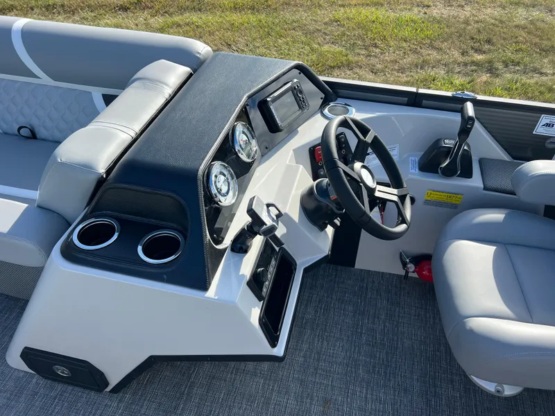 Slide: The Image of 2025 Crest CLASSIC 220 SLC boat dashboard with steering wheel and controls. - 27
