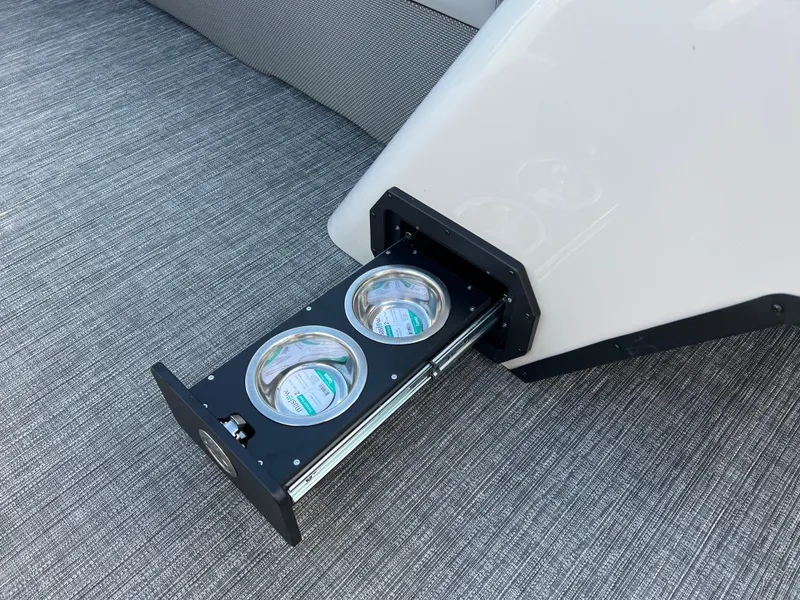 Slide: The Image of Pull-out pet bowls on 2025 Crest CLASSIC 220 SLC boat, gray carpet background. - 28