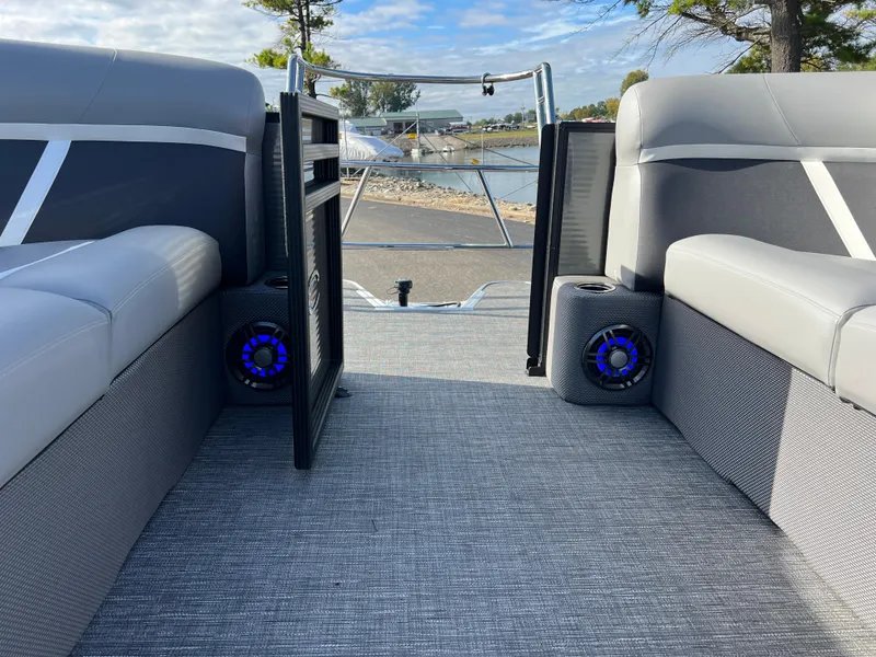 Slide: The Image of 2025 Crest CLASSIC 220 SLC boat interior with gray seating and blue speakers. - 31