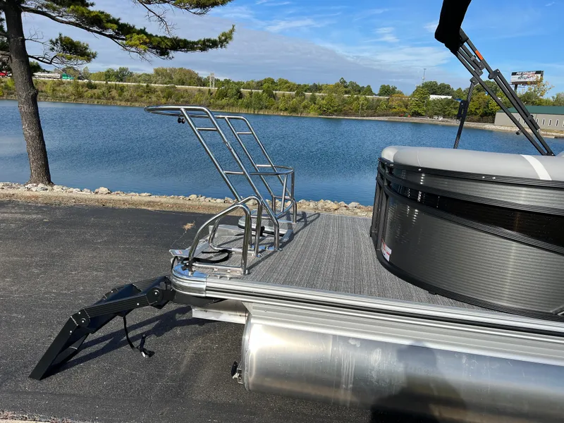 Slide: The Image of 2025 Crest CLASSIC 220 SLC pontoon boat by a serene lake. - 6