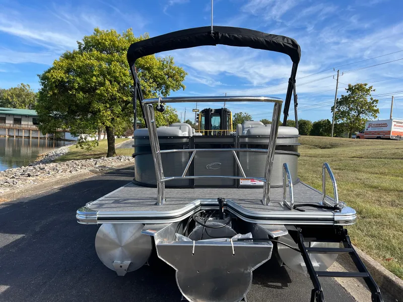 Slide: The Image of 2025 Crest CLASSIC 220 SLC pontoon boat parked on a sunny day by a lake. - 7
