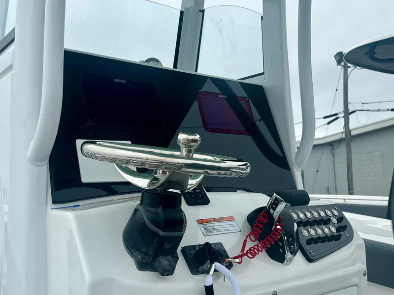 Slide: The Image of 2025 NauticStar 242OSL boat with teal T-top and rod holders. - 3
