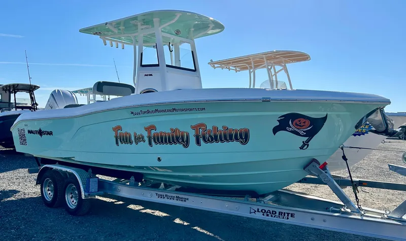 Slide: The Image of 2025 NauticStar 242OSL boat dashboard with steering wheel and control panel. - 4