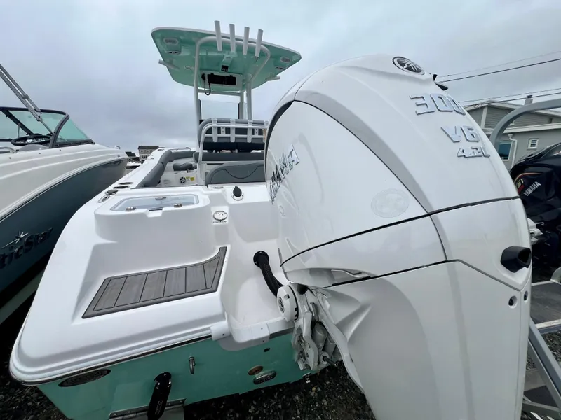 Slide: The Image of 2025 NauticStar 242OSL boat on trailer, featuring Yamaha outboard motor. - 6