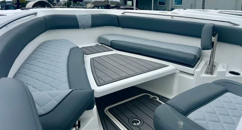 Slide: The Image of 2025 NauticStar 242OSL boat with powerful outboard motor, docked outdoors. - 7