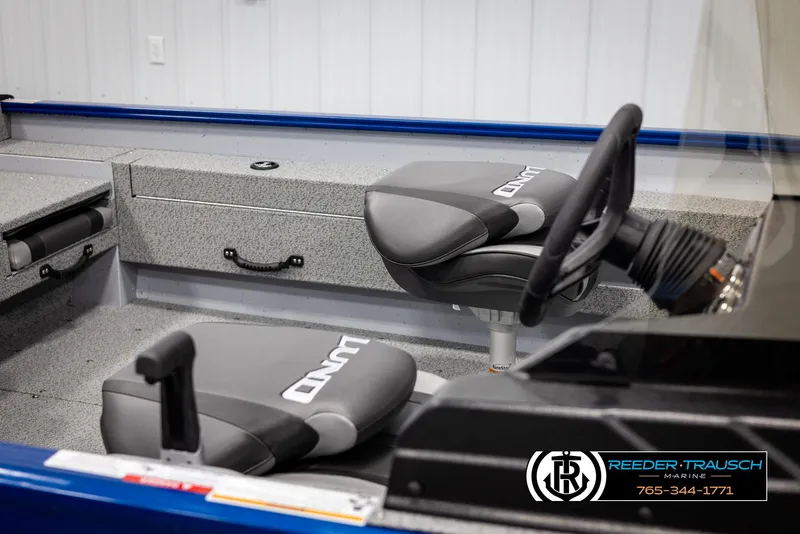 Slide: The Image of 2025 Lund 1775 Adventure SS boat interior with steering wheel and branded seats. - 15