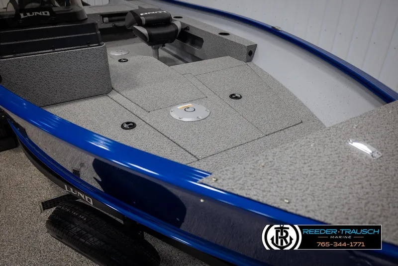 Slide: The Image of 2025 Lund 1775 Adventure SS boat interior with blue trim and gray deck. - 16