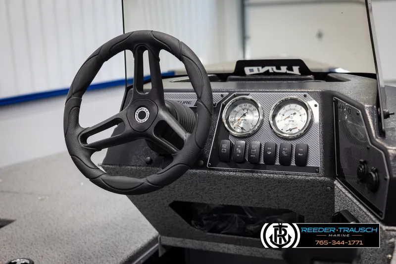 Slide: The Image of 2025 Lund 1775 Adventure SS boat dashboard with steering wheel and gauges. - 18