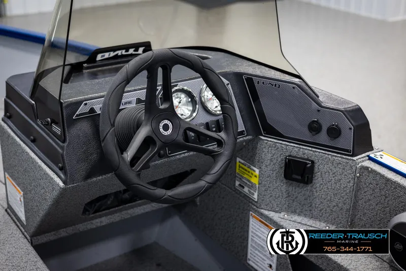 Slide: The Image of 2025 Lund 1775 Adventure SS boat dashboard with steering wheel and gauges. - 19