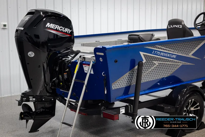 Slide: The Image of 2025 Lund 1775 Adventure SS boat with Mercury outboard motor, blue exterior, and ladder. - 31