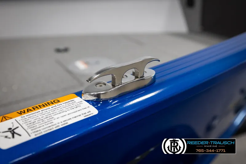 Slide: The Image of 2025 Lund 1775 Adventure SS boat cleat on blue surface with warning label. - 41