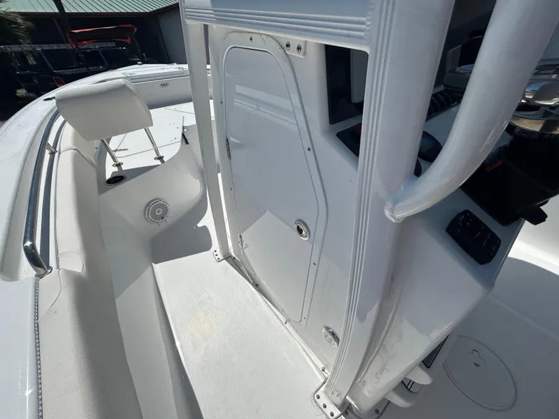Slide: The Image of 2025 Sea Hunt Ultra 229 boat interior with white seating and console. - 10
