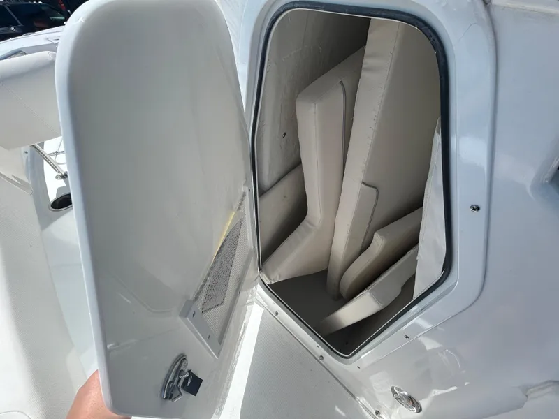 Slide: The Image of Open storage compartment on 2025 Sea Hunt Ultra 229 boat with cushions inside. - 11
