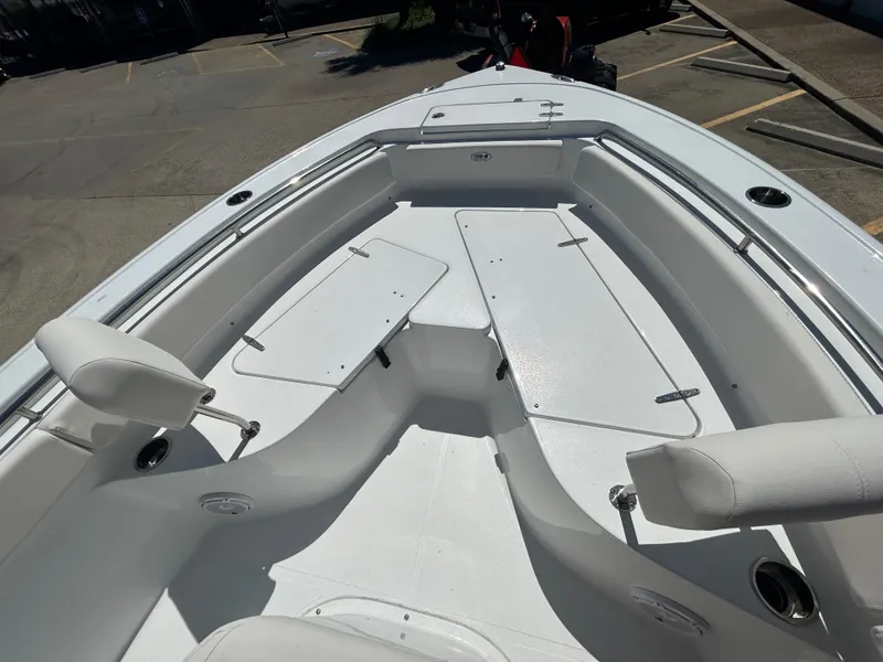 Slide: The Image of 2025 Sea Hunt Ultra 229 boat interior with white seating and storage compartments. - 15
