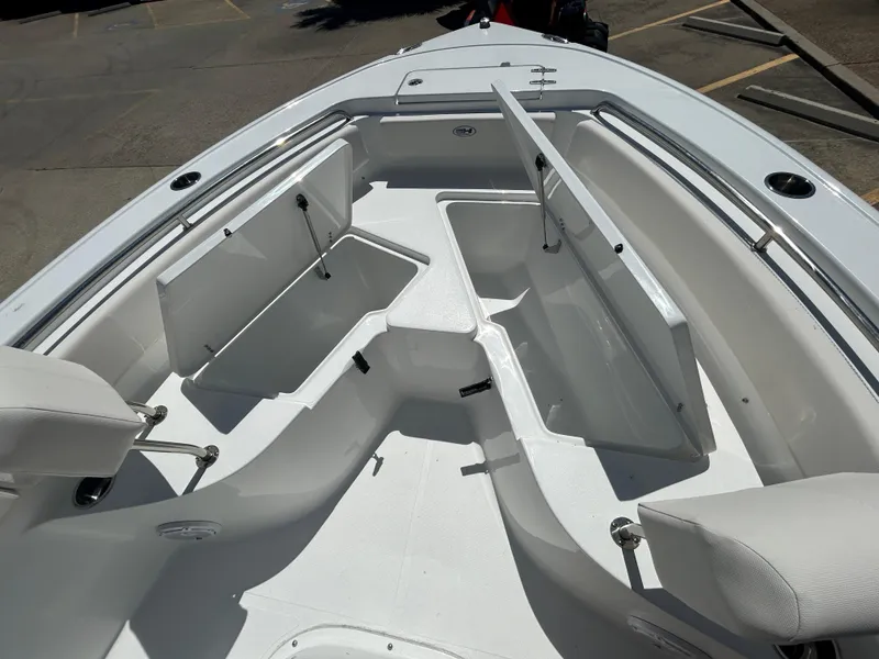 Slide: The Image of 2025 Sea Hunt Ultra 229 boat with open storage compartments. - 16
