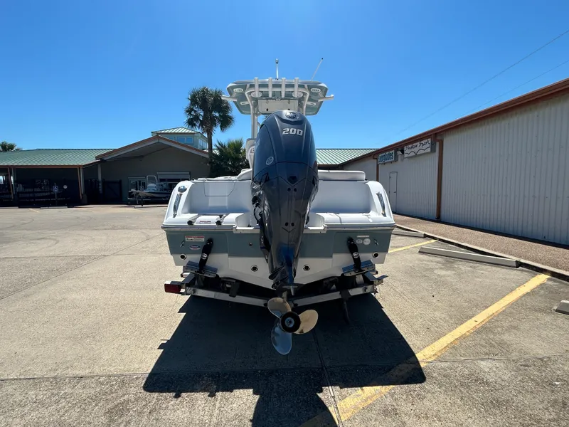 Slide: The Image of 2025 Sea Hunt Ultra 229 boat with Yamaha 200 engine, parked outdoors. - 6