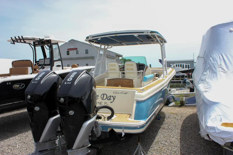 Slide: The Image of 2011 Chris-Craft Catalina 29 Sun Tender with dual outboard engines, docked outdoors. - 0