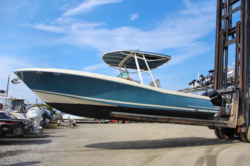 Slide: The Image of 2011 Chris-Craft Catalina 29 Sun Tender on forklift, blue hull, sunny day. - 12