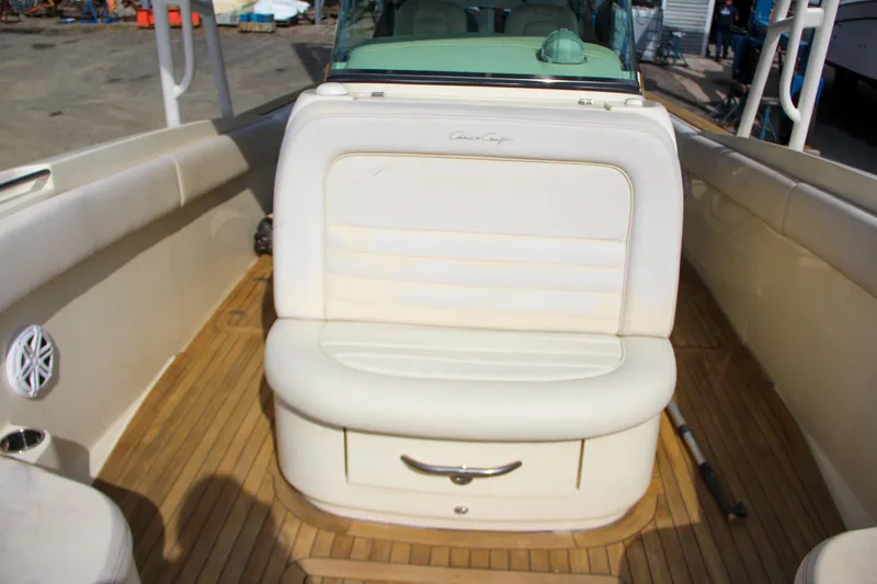 Slide: The Image of 2011 Chris-Craft Catalina 29 Sun Tender interior with beige seating and wooden deck. - 17