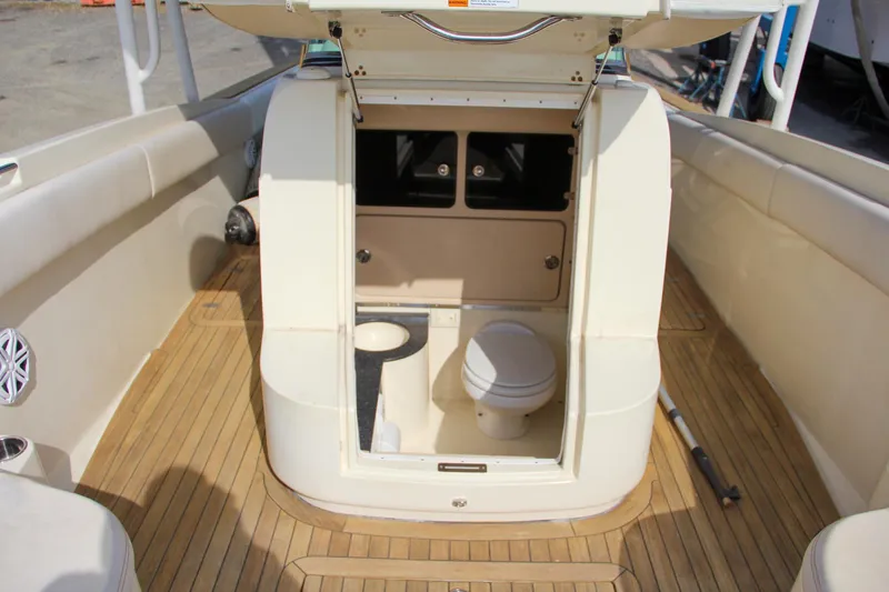 Slide: The Image of 2011 Chris-Craft Catalina 29 Sun Tender interior with teak flooring and marine toilet. - 20