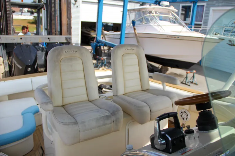 Slide: The Image of 2011 Chris-Craft Catalina 29 Sun Tender interior with dual captain seats and control panel. - 22