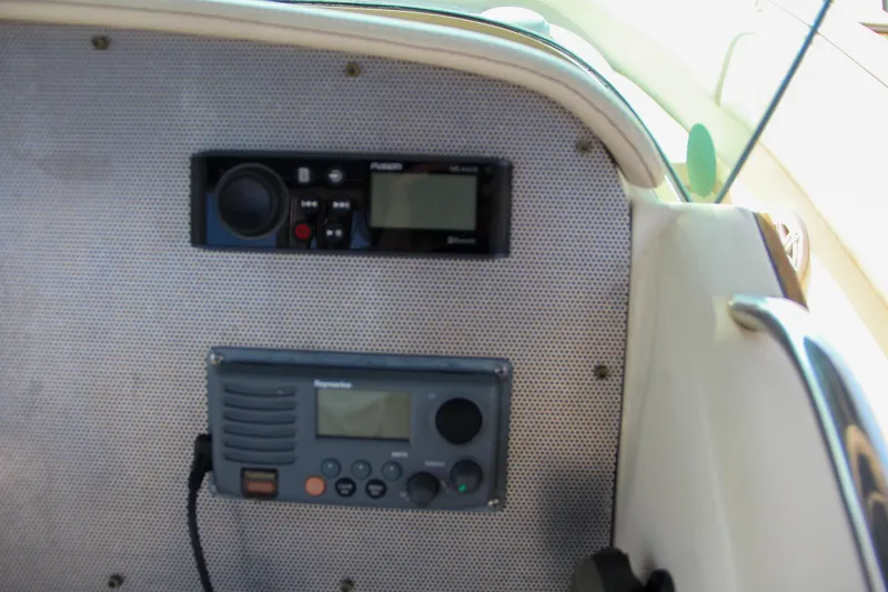 Slide: The Image of 2011 Chris-Craft Catalina 29 Sun Tender dashboard with radio and navigation equipment. - 23