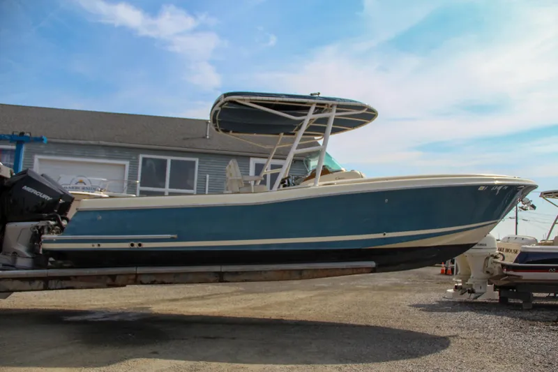 Slide: The Image of 2011 Chris-Craft Catalina 29 Sun Tender boat on trailer, blue hull, clear sky background. - 30